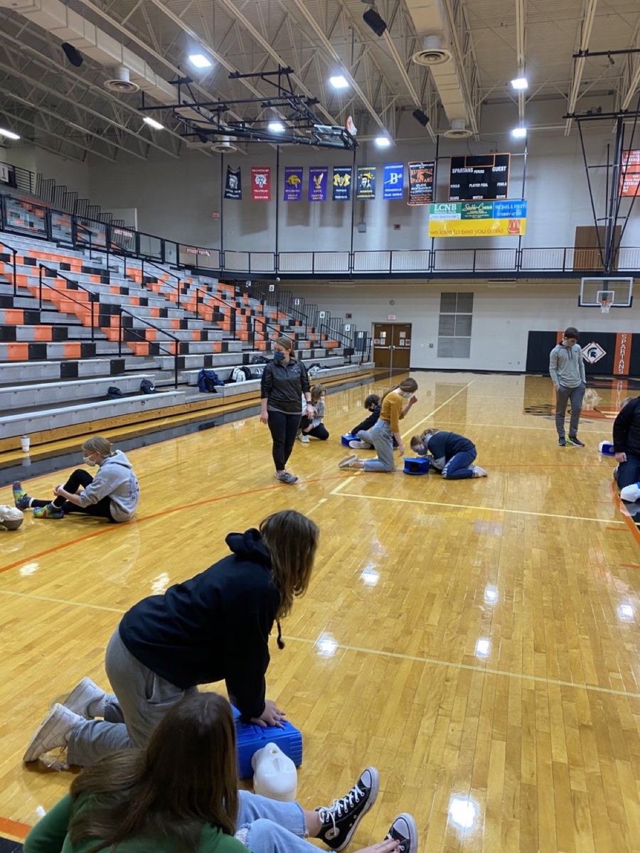 Students in a gym doing CPR