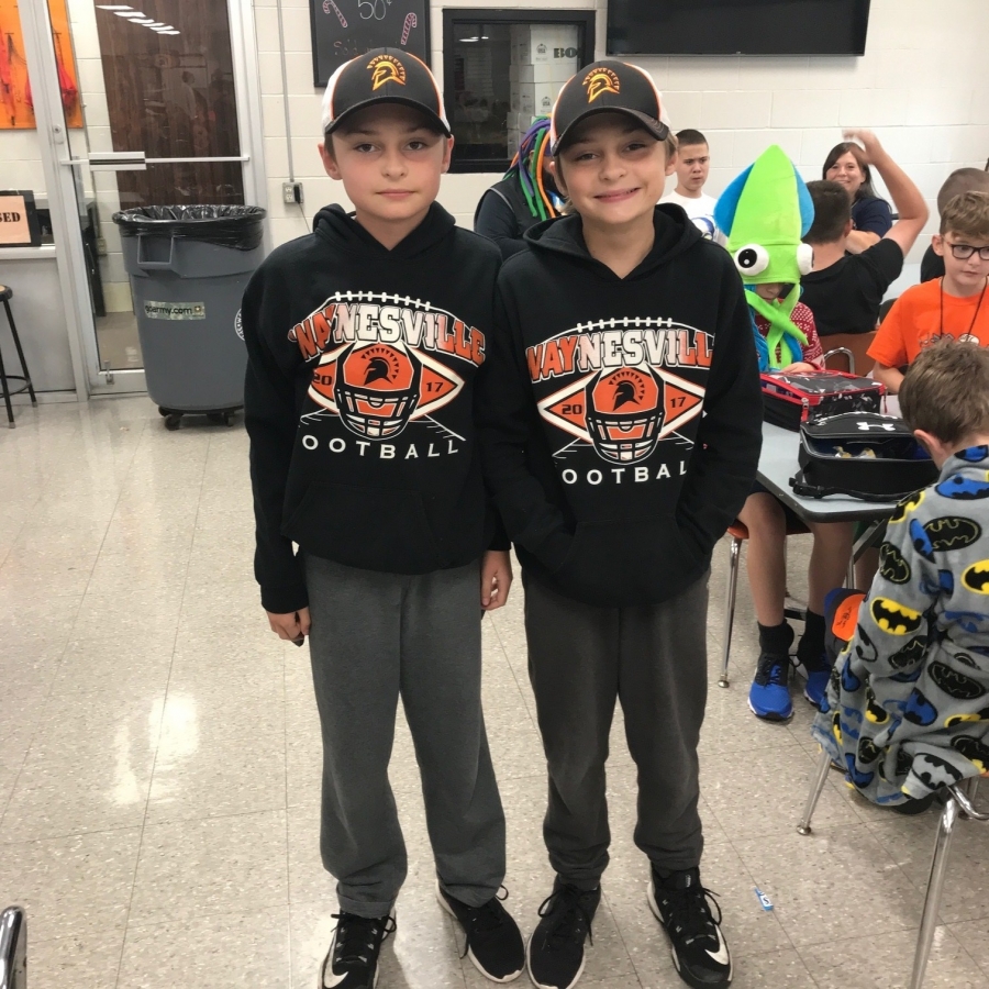two boys wearing matching hoodies
