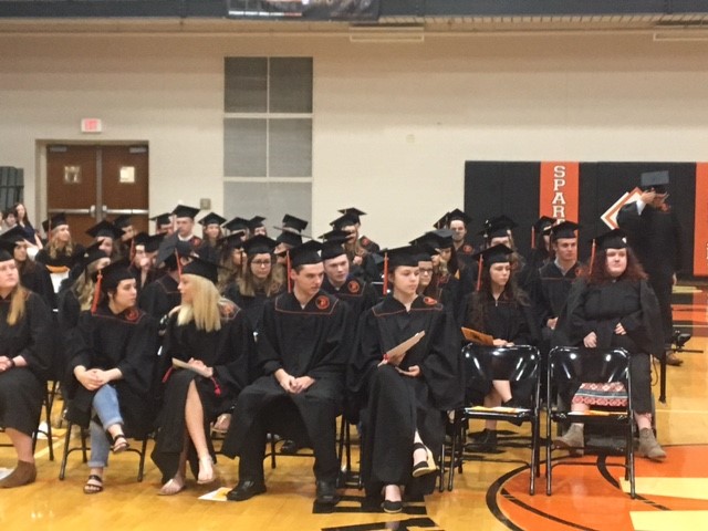 graduates sitting in chairs