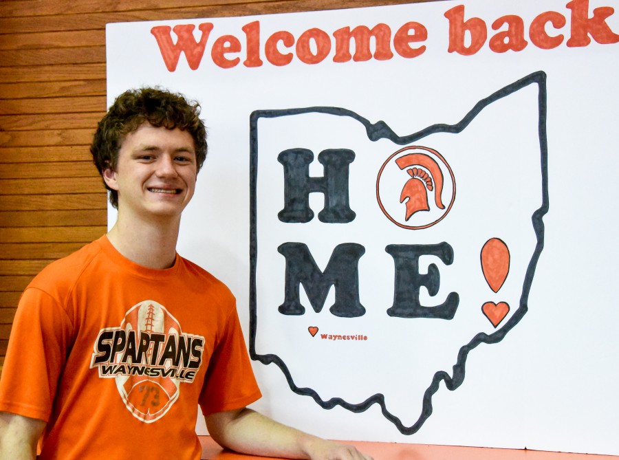 image of a boy with the state of Ohio poster behind him