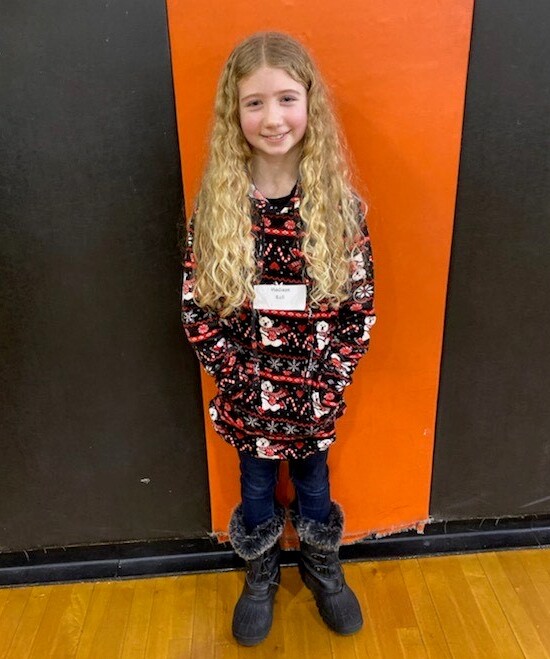 girl standing in front of orange and black